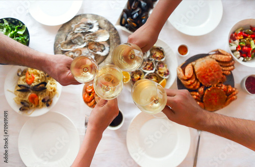 People fine dining seafood and white wine on the table photo