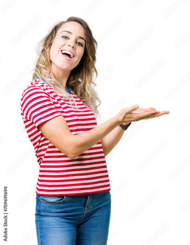 Beautiful young blonde woman over isolated background Pointing to the side with hand and open palm, presenting ad smiling happy and confident Beautiful young blonde woman over isolated background Pointing to the side with hand and open palm, presenting ad smiling happy and confident