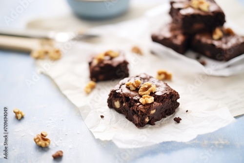 dark chocolate brownies with walnuts on a parchment paper