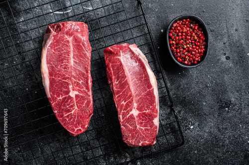 Raw top blade cut organic beef meat.  Black background. Top View