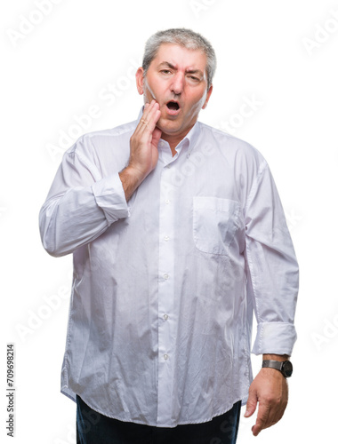 Handsome senior man over isolated background touching mouth with hand with painful expression because of toothache or dental illness on teeth. Dentist concept. © Krakenimages.com