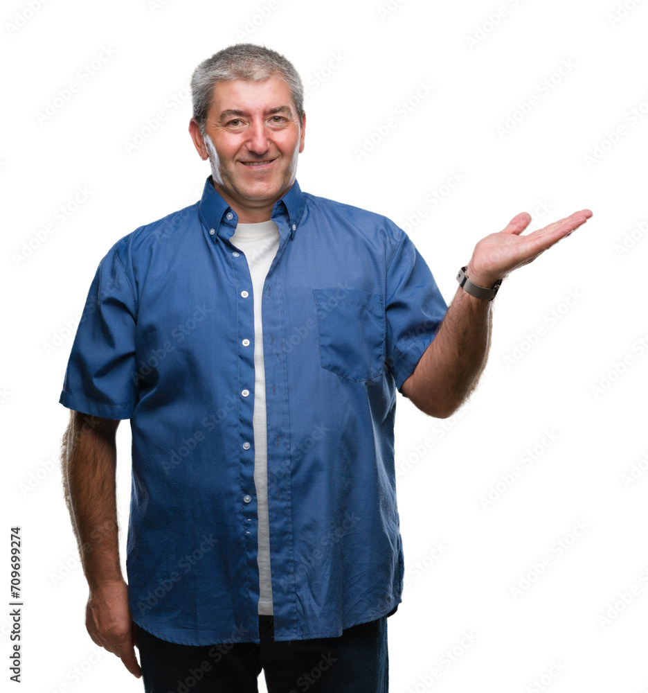 Handsome senior man over isolated background smiling cheerful presenting and pointing with palm of hand looking at the camera. Handsome senior man over isolated background smiling cheerful presenting and pointing with palm of hand looking at the camera.