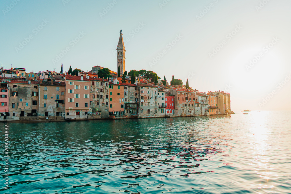 Fototapeta premium Scenic view of the colorful houses on the coastline in Rovinj, Croatia at golden sunset