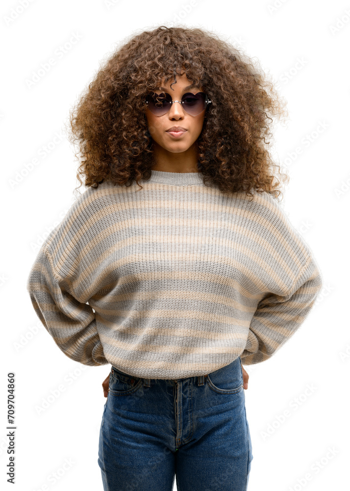 African american woman wearing a stripes sweater with a confident expression on smart face thinking serious African american woman wearing a stripes sweater with a confident expression on smart face thinking serious