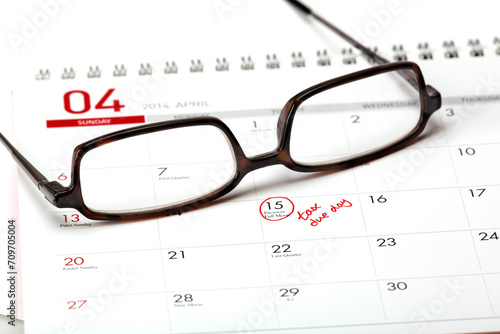 Close-Up 4K Ultra HD Image of Tax Due Date on Calendar with Eyeglasses