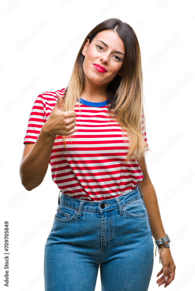 Young beautiful woman casual look over isolated background doing happy thumbs up gesture with hand. Approving expression looking at the camera with showing success. Young beautiful woman casual look over isolated background doing happy thumbs up gesture with hand. Approving expression looking at the camera with showing success.