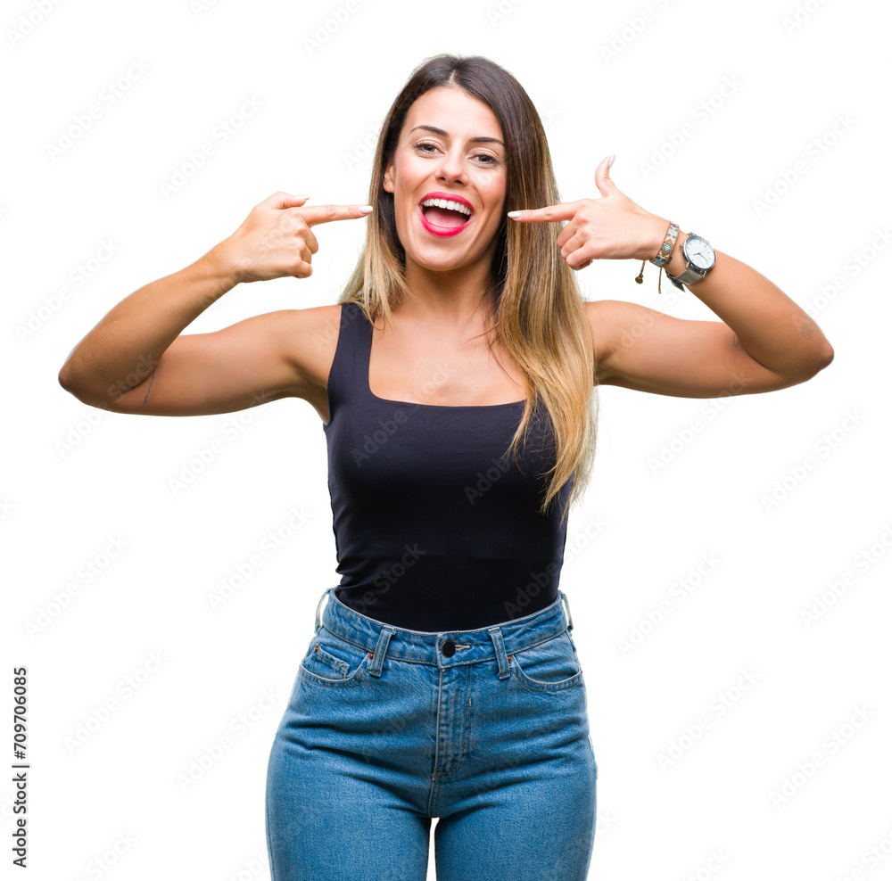 Young beautiful woman over isolated background smiling confident showing and pointing with fingers teeth and mouth. Health concept. Young beautiful woman over isolated background smiling confident showing and pointing with fingers teeth and mouth. Health concept.