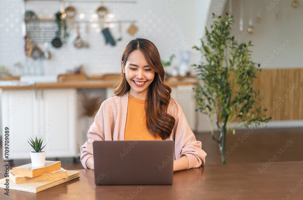 Young smiling asian woman happy relax use laptop conference work,learning, education, shopping, study online, webinar, online marketing, business, blog, digital internet advertising at home Young smiling asian woman happy relax use laptop conference work,learning, education, shopping, study online, webinar, online marketing, business, blog, digital internet advertising at home