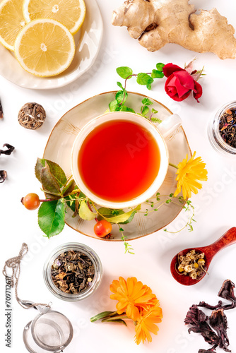 Tea with different ingredients. Herbs, fruits, and flowers, overhead flat lay shot on a white background. Healthy natural remedies