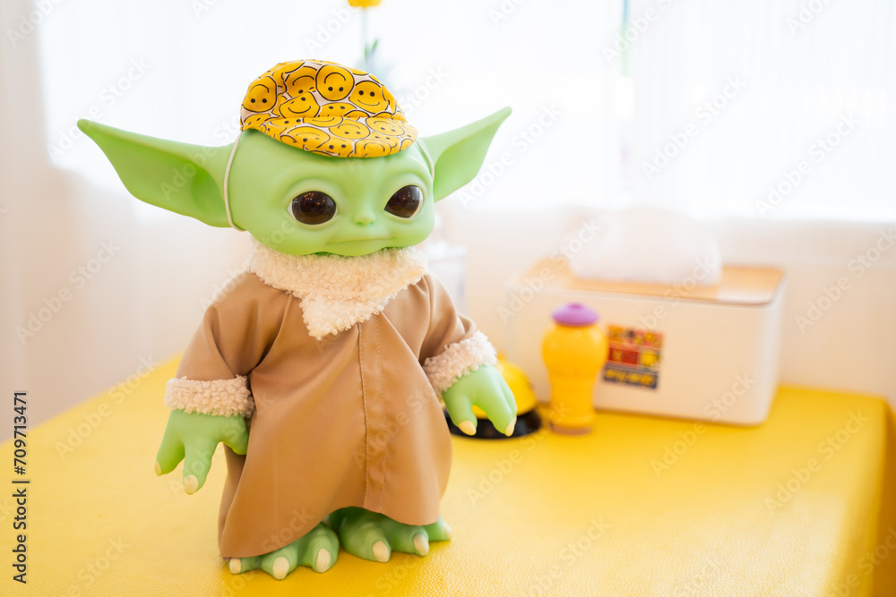 Naklejka premium Bangkok, Thailand, January 12, 2024. Close-up of Green Yoda from Star Wars figure on tabletop
