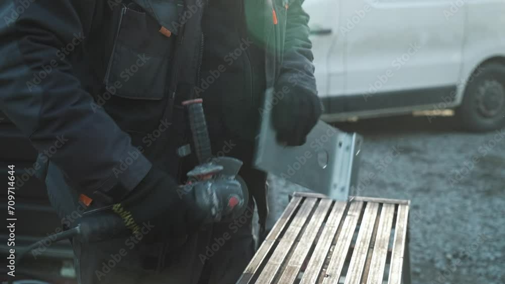 Worker cutting metal tube using an Angle Grinder. Bright sparks and flashes Worker cutting metal tube using an Angle Grinder. Bright sparks and flashes