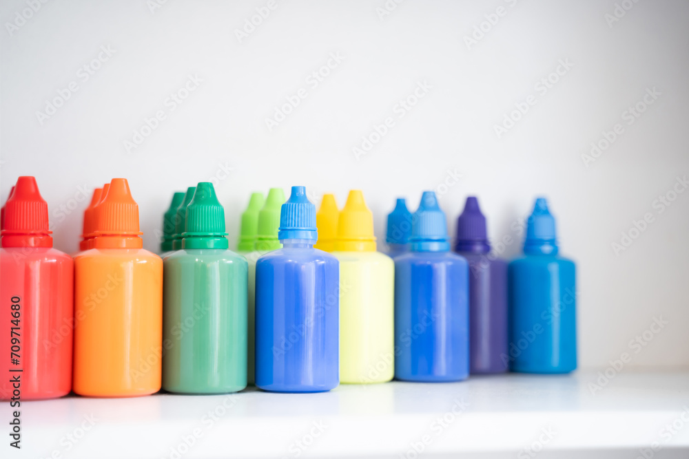 Bottles of art paints of various colors were lined up in large numbers Bottles of art paints of various colors were lined up in large numbers