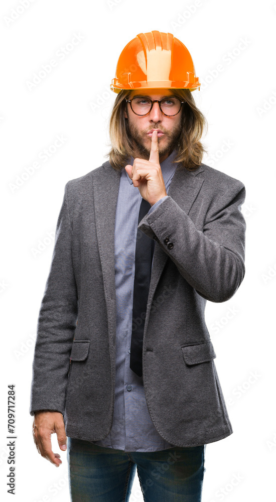 Young handsome architec man with long hair wearing safety helmet over isolated background asking to be quiet with finger on lips. Silence and secret concept. Young handsome architec man with long hair wearing safety helmet over isolated background asking to be quiet with finger on lips. Silence and secret concept.