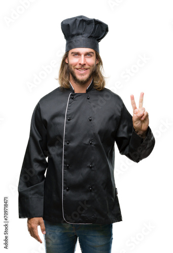 Young handsome cook man with long hair over isolated background showing and pointing up with fingers number two while smiling confident and happy.