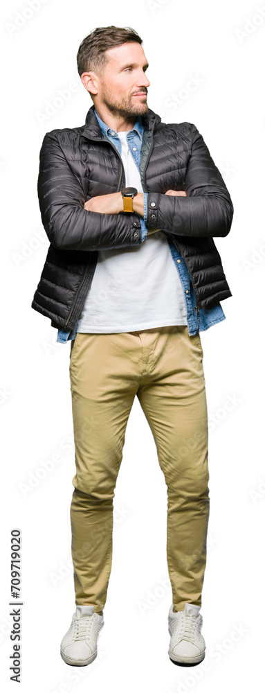 Handsome man wearing winter coat smiling looking to the side with arms crossed convinced and confident Handsome man wearing winter coat smiling looking to the side with arms crossed convinced and confident