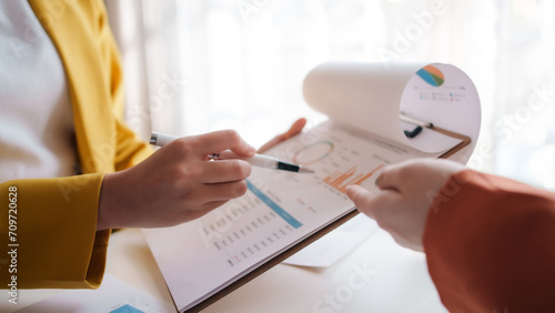 Business team analyzing financial documents. Meeting of businesswomen pointing at graph.