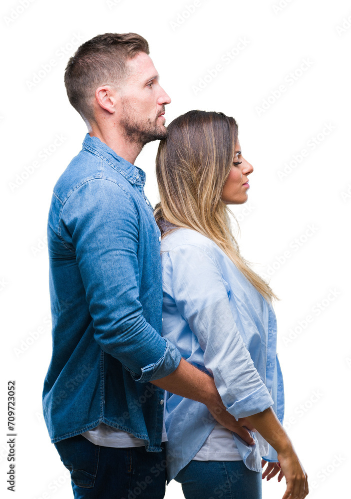 Young couple in love over isolated background looking to side, relax profile pose with natural face with confident smile. Young couple in love over isolated background looking to side, relax profile pose with natural face with confident smile.
