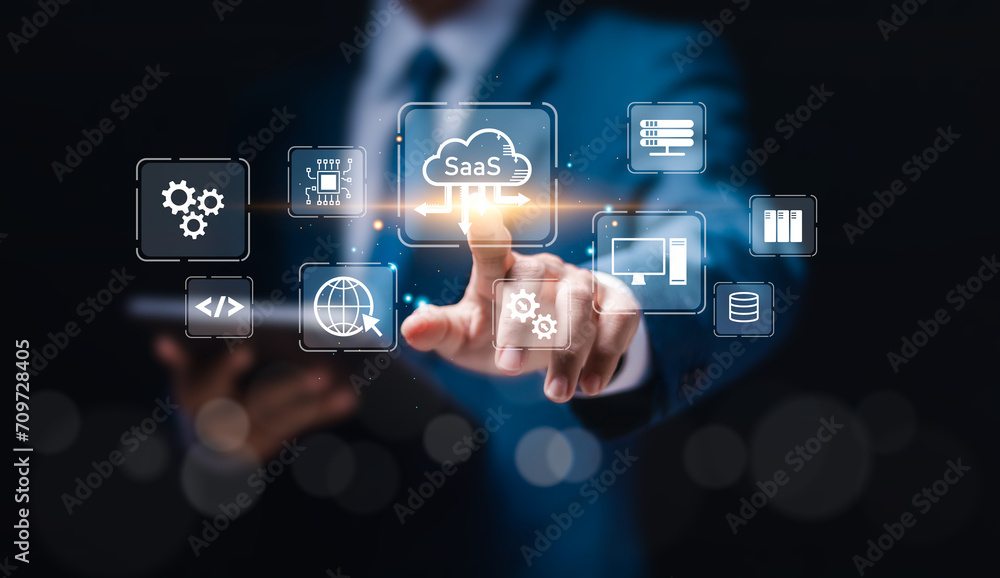 SaaS (software as a service) concept, Businessman touch virtual screen of SaaS icons for software services on cloud system. Internet and networking technology. SaaS (software as a service) concept, Businessman touch virtual screen of SaaS icons for software services on cloud system. Internet and networking technology.