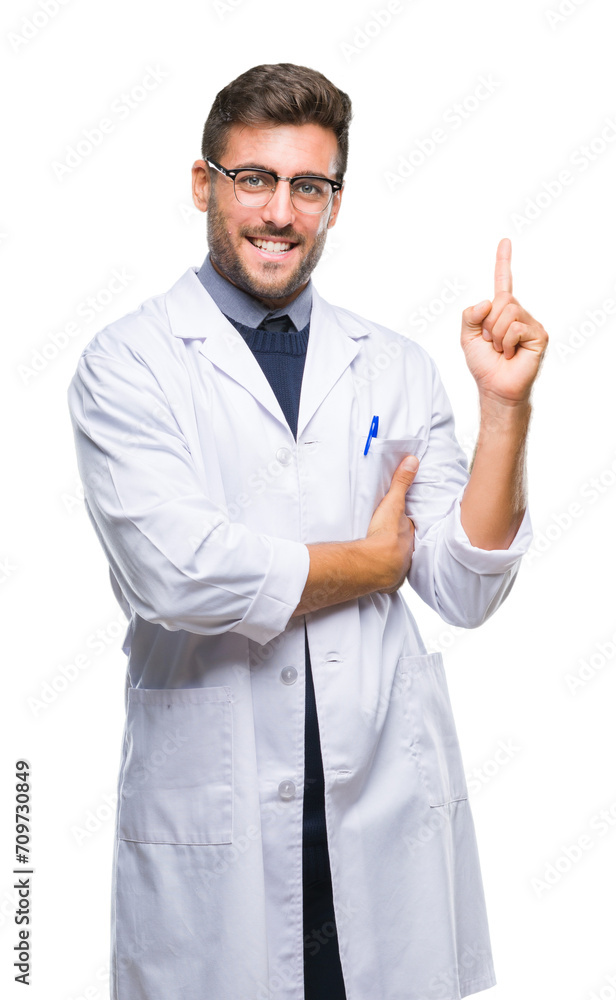Young handsome man wearing doctor, scientis coat over isolated background with a big smile on face, pointing with hand and finger to the side looking at the camera. Young handsome man wearing doctor, scientis coat over isolated background with a big smile on face, pointing with hand and finger to the side looking at the camera.