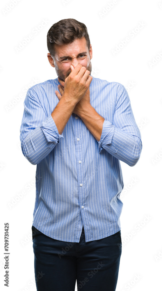 Young handsome man over isolated background smelling something stinky and disgusting, intolerable smell, holding breath with fingers on nose. Bad smells concept. Young handsome man over isolated background smelling something stinky and disgusting, intolerable smell, holding breath with fingers on nose. Bad smells concept.