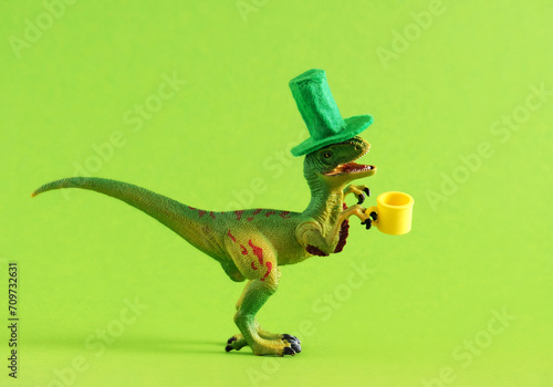 Funny dinosaur in green hat with beer  celebrating St. Patrick's day. © dvulikaia