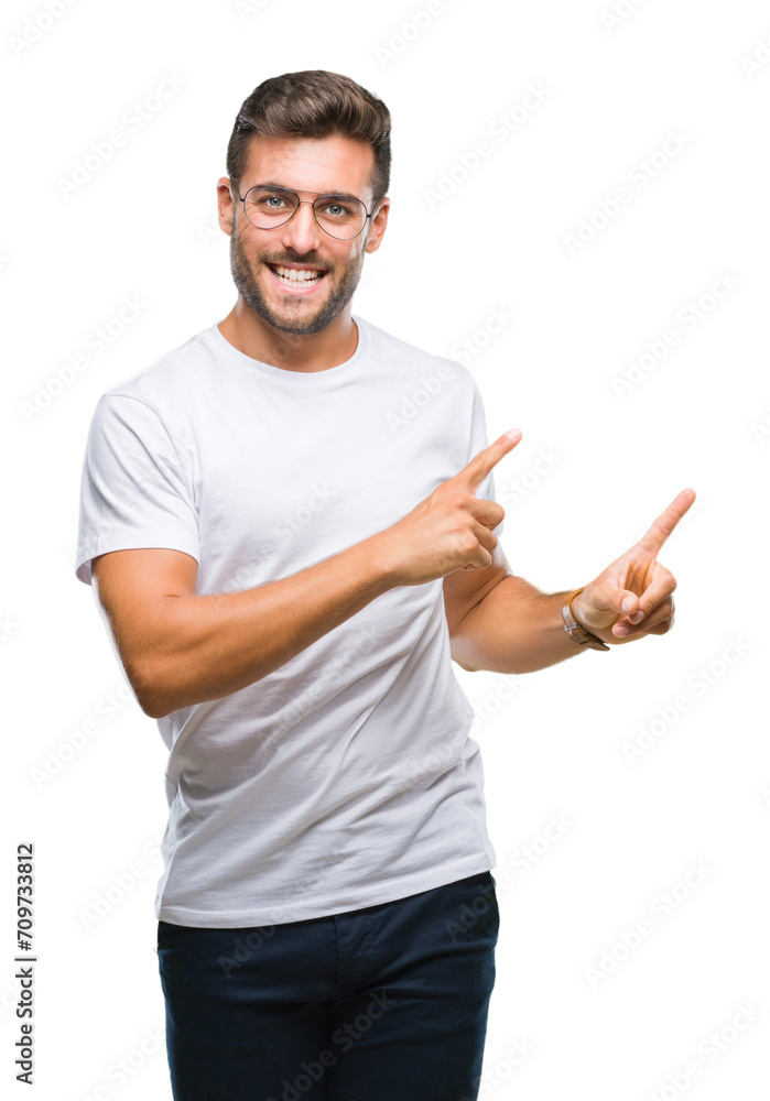 Young handsome man wearing glasses over isolated background smiling and looking at the camera pointing with two hands and fingers to the side. Young handsome man wearing glasses over isolated background smiling and looking at the camera pointing with two hands and fingers to the side.