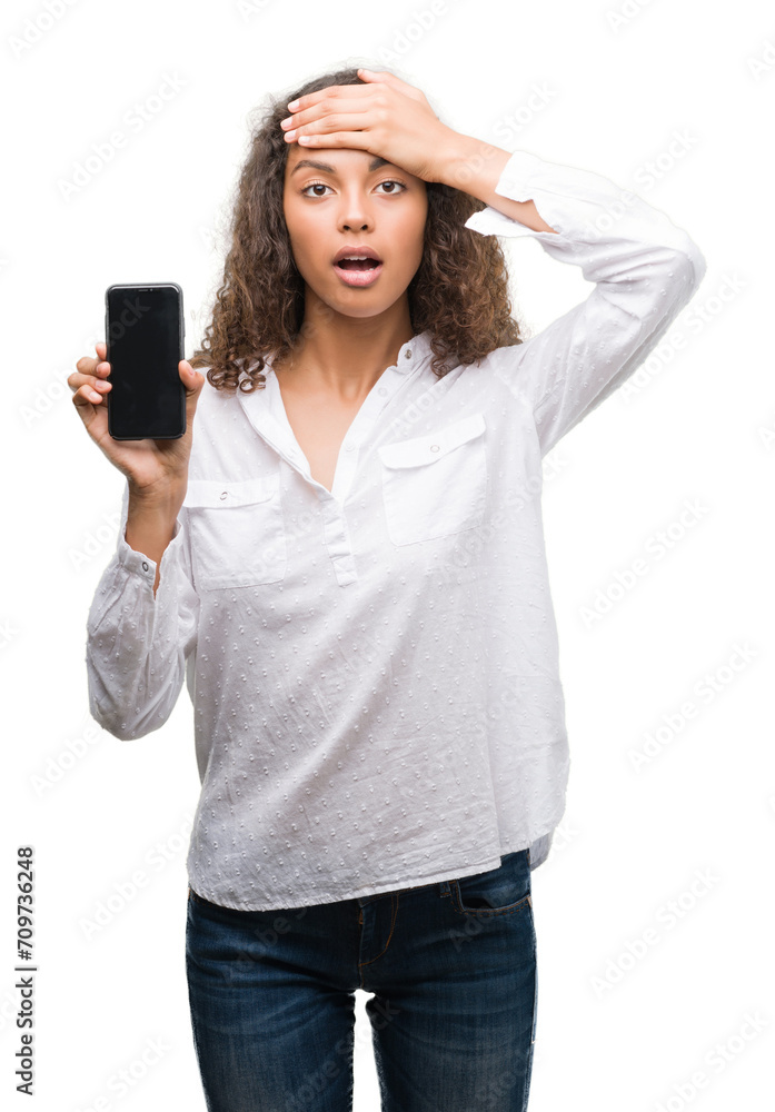 Young hispanic woman using smartphone stressed with hand on head, shocked with shame and surprise face, angry and frustrated. Fear and upset for mistake. Young hispanic woman using smartphone stressed with hand on head, shocked with shame and surprise face, angry and frustrated. Fear and upset for mistake.