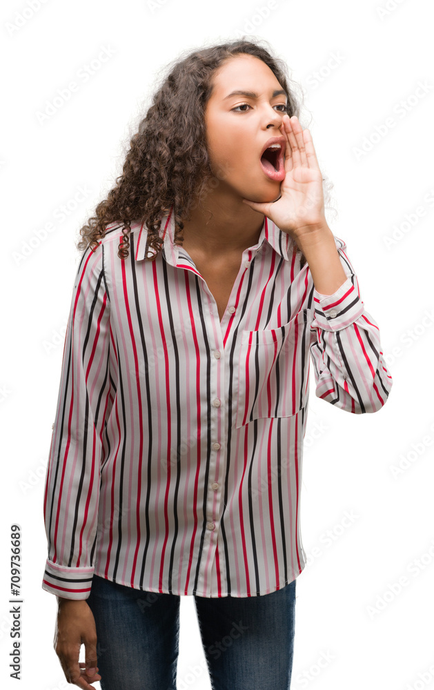 Beautiful young hispanic woman shouting and screaming loud to side with hand on mouth. Communication concept. Beautiful young hispanic woman shouting and screaming loud to side with hand on mouth. Communication concept.