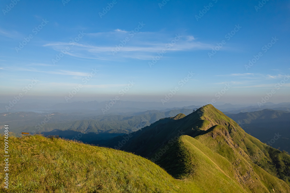 Obraz premium Green yellow mountains and beautiful sky clouds under the blue sky.