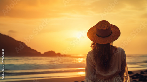 Lonely woman standing on beach sunrise time.