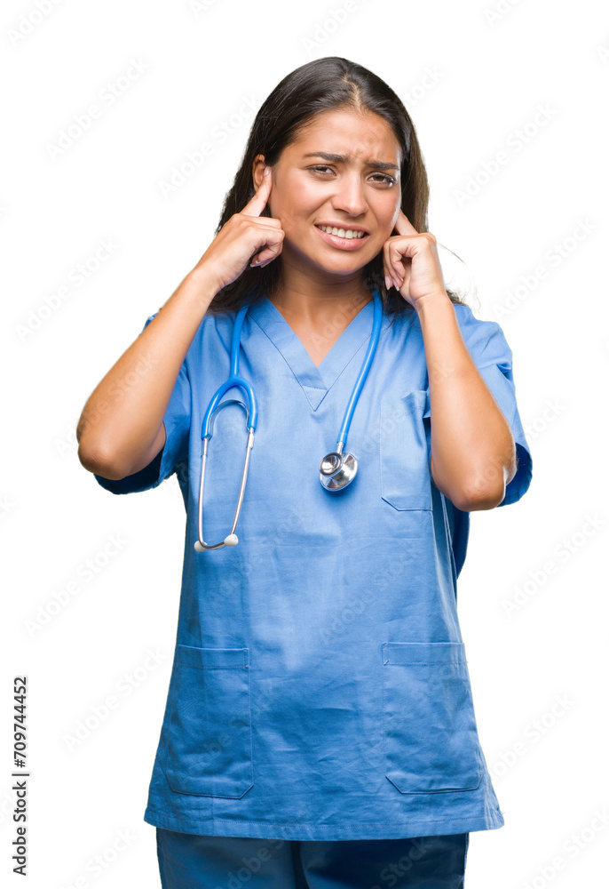 Young arab doctor surgeon woman over isolated background covering ears with fingers with annoyed expression for the noise of loud music. Deaf concept. Young arab doctor surgeon woman over isolated background covering ears with fingers with annoyed expression for the noise of loud music. Deaf concept.