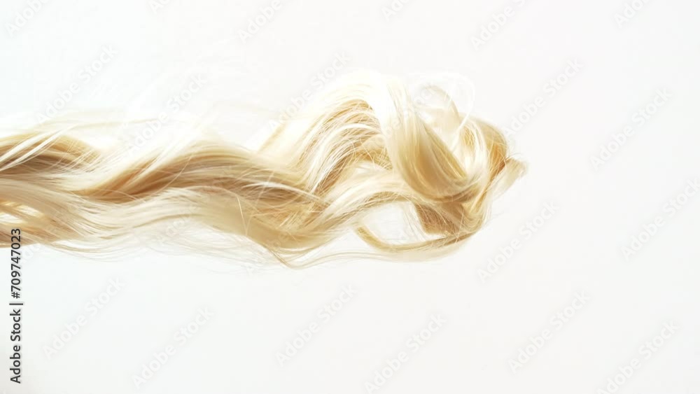 Waving of locks of blond shiny wavy bunch hair. Slow Motion. Hair care and beauty salon. Natural cosmetic products. Hair color palette. . High quality 4k footage Waving of locks of blond shiny wavy bunch hair. Slow Motion. Hair care and beauty salon. Natural cosmetic products. Hair color palette. . High quality 4k footage