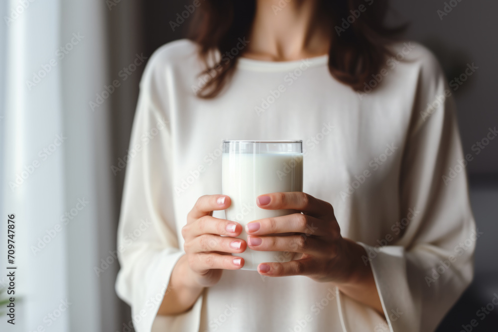Young woman drinks calciumrich milk for strong bones. Young woman drinks calciumrich milk for strong bones.