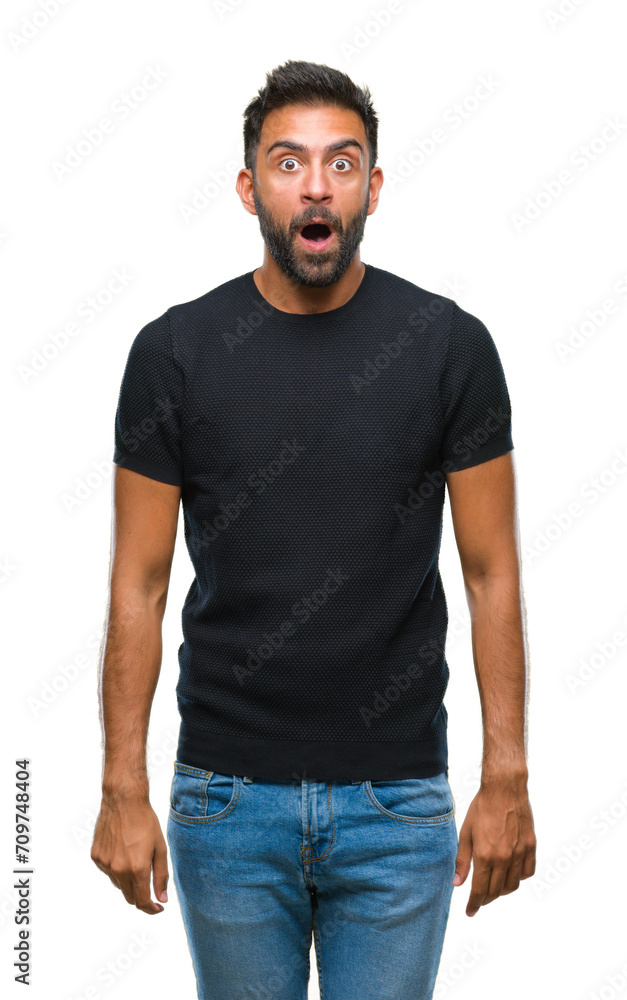 Adult hispanic man over isolated background afraid and shocked with surprise expression, fear and excited face. Adult hispanic man over isolated background afraid and shocked with surprise expression, fear and excited face.