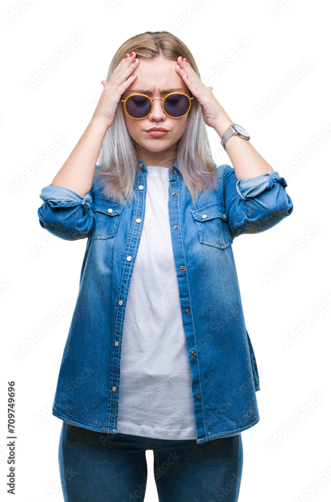 Young blonde woman wearing sunglasses over isolated background suffering from headache desperate and stressed because pain and migraine. Hands on head. Young blonde woman wearing sunglasses over isolated background suffering from headache desperate and stressed because pain and migraine. Hands on head.