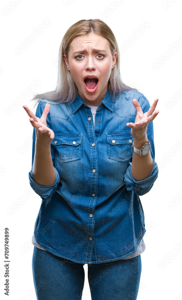 Young blonde woman over isolated background crazy and mad shouting and yelling with aggressive expression and arms raised. Frustration concept. Young blonde woman over isolated background crazy and mad shouting and yelling with aggressive expression and arms raised. Frustration concept.