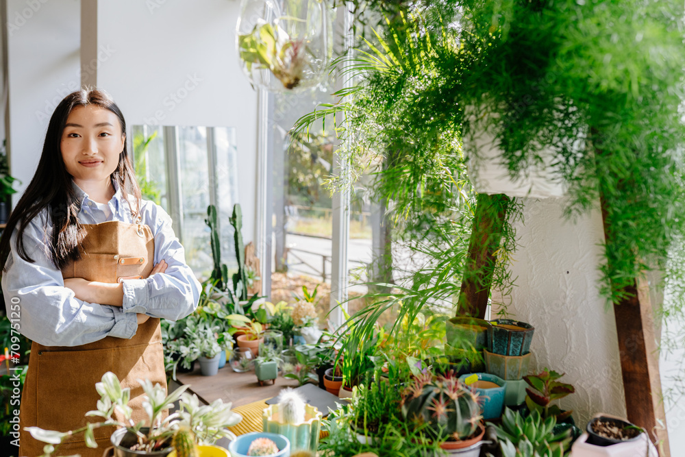 Small business, home decor concept. Portrait of professional . confident young Asian female florist, owner of small business flower shop. Copy space text. Small business, home decor concept. Portrait of professional . confident young Asian female florist, owner of small business flower shop. Copy space text.