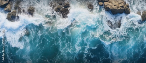 drone footage picture of oceanic blue waves bumping into the rocks