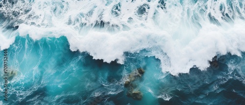drone footage picture of oceanic blue waves bumping into the rocks
