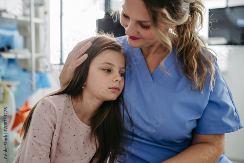 Wallpaper Mural Supportive doctor soothing a worried children patient in emergency room. Hugging little girl before surgery. Hugging little girl before surgery. Concept of emotional support and friendliness for young Torontodigital.ca