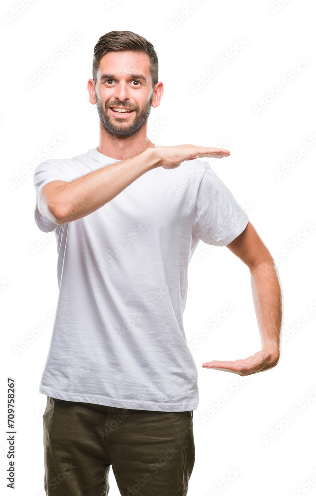 Young handsome man over isolated background gesturing with hands showing big and large size sign, measure symbol. Smiling looking at the camera. Measuring concept. Young handsome man over isolated background gesturing with hands showing big and large size sign, measure symbol. Smiling looking at the camera. Measuring concept.