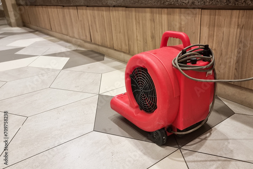 Close-up of portable floor dryer fan used in public washroom and toilet to dry the floor after washing and cleaning photo