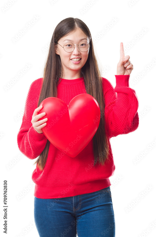 Young Chinese woman wearing graduate uniform red heart surprised with an idea or question pointing finger with happy face, number one Young Chinese woman wearing graduate uniform red heart surprised with an idea or question pointing finger with happy face, number one
