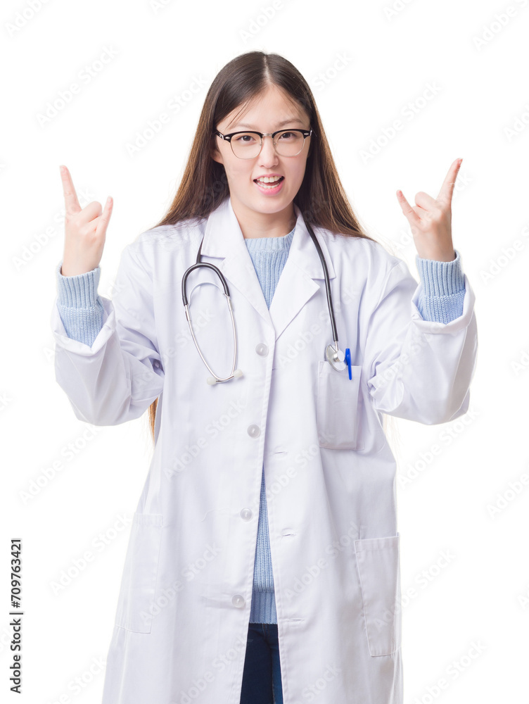 Young Chinese doctor woman over isolated background shouting with crazy expression doing rock symbol with hands up. Music star. Heavy concept. Young Chinese doctor woman over isolated background shouting with crazy expression doing rock symbol with hands up. Music star. Heavy concept.