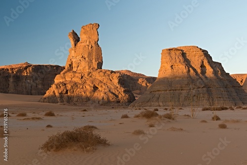 View of the rock formations Playa of Moul Naga at sunrise of the Tadrart Rouge rocky mountain range in Tassili n Ajjer National Park. Sahara desert, Algeria, Africa.