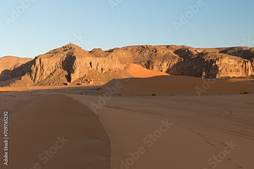 View of the rock formations Playa of Moul Naga at sunrise of the Tadrart Rouge rocky mountain range in Tassili n Ajjer National Park. Sahara desert  Algeria  Africa.