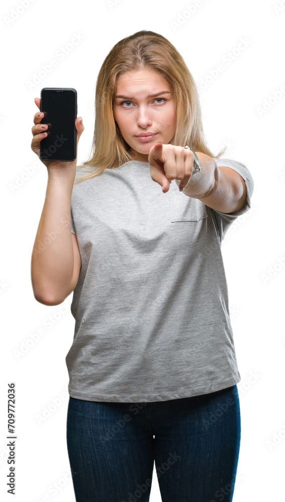 Young caucasian woman showing screen of smartphone over isolated background pointing with finger to the camera and to you, hand sign, positive and confident gesture from the front Young caucasian woman showing screen of smartphone over isolated background pointing with finger to the camera and to you, hand sign, positive and confident gesture from the front
