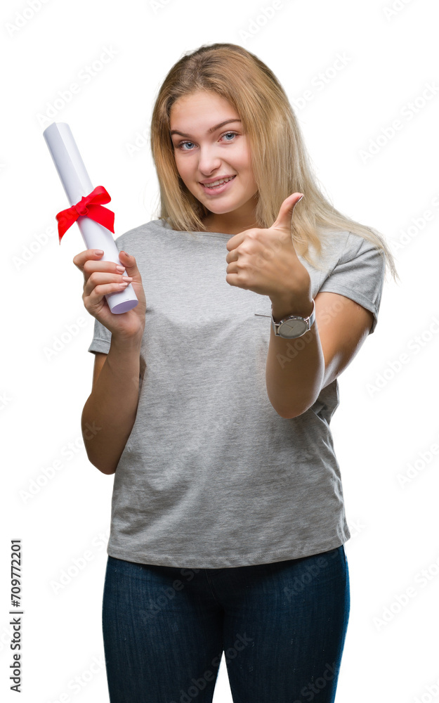 Young caucasian woman holding degree over isolated background happy with big smile doing ok sign, thumb up with fingers, excellent sign Young caucasian woman holding degree over isolated background happy with big smile doing ok sign, thumb up with fingers, excellent sign