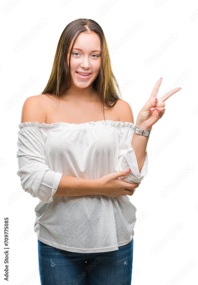Young caucasian beautiful woman over isolated background smiling with happy face winking at the camera doing victory sign. Number two.