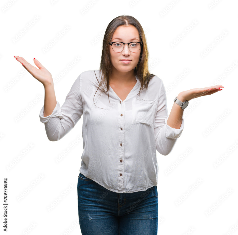 Young caucasian beautiful business woman wearing glasses over isolated background clueless and confused expression with arms and hands raised. Doubt concept. Young caucasian beautiful business woman wearing glasses over isolated background clueless and confused expression with arms and hands raised. Doubt concept.